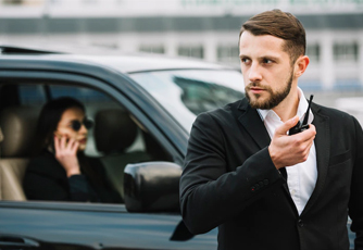 Security guard providing customer service while maintaining vigilance.