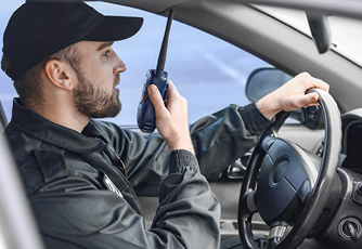 Security guard on vehicle communicating via a two-way radio