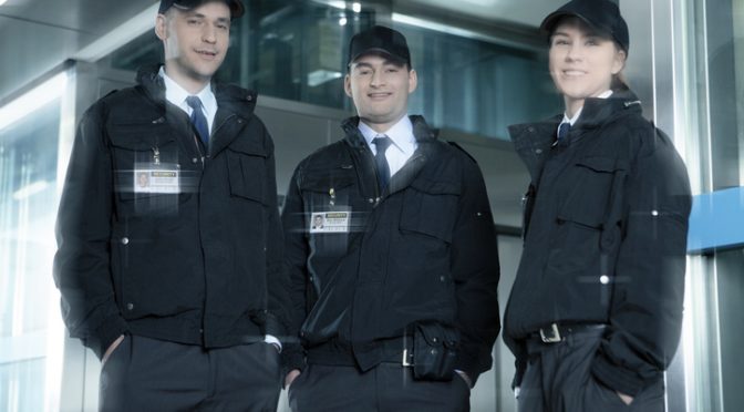 Portrait of security guards standing in corridor near elevator